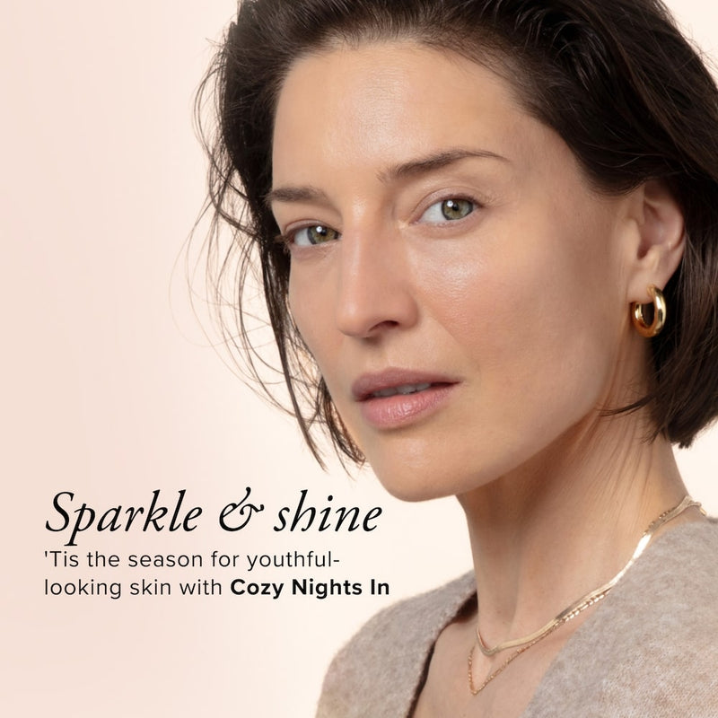 a beautiful white woman with brown hair and gold jewelry looking into the camera with text that says Sparkle and shine, tis the season for youthful-looking skin with Cozy Nights In