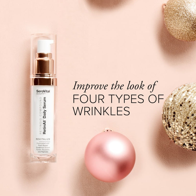 A tube of anti-wrinkle serum RetinAll Daily Serum on a pink background with holiday ornaments and text that says Improve the look of four types of wrinkles