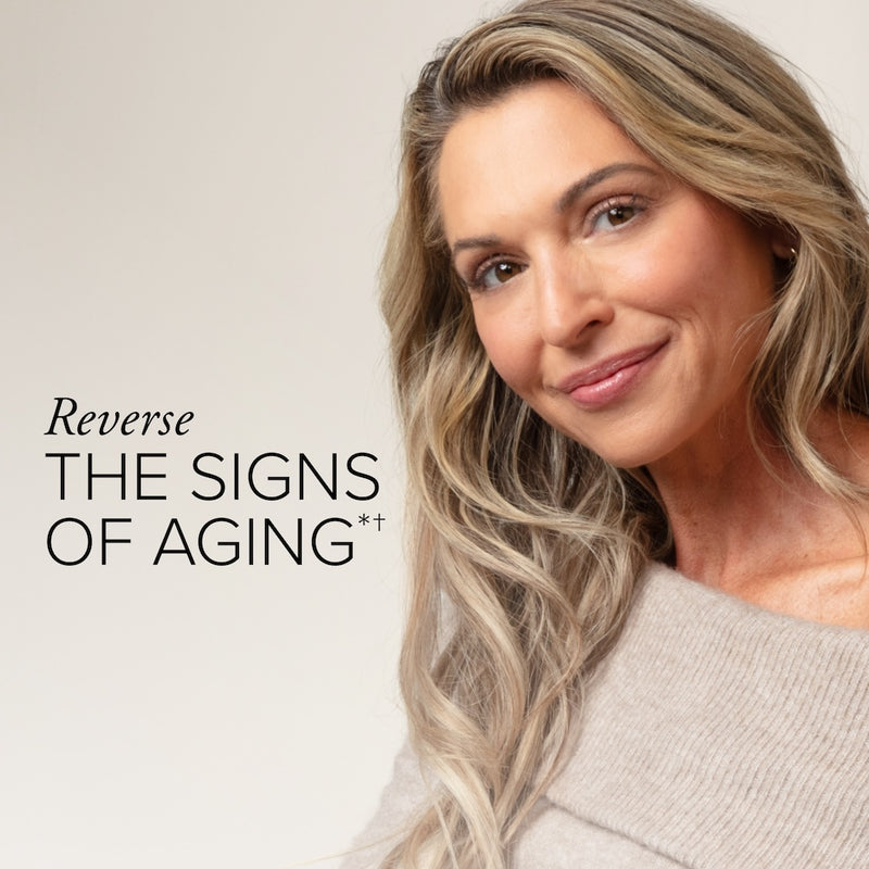 A beautiful white woman with long blond hair in a brown sweater next to text that says reverse the signs of aging.