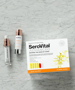 A tube of hyaluronic acid serum TriHydrate, retinoid serum RetinAll, and beauty boosting SeroVital ADVANCED lying on a marbled background